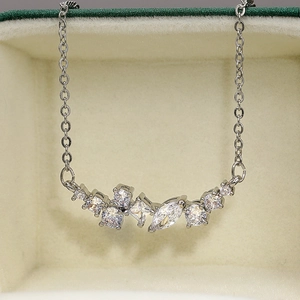 Macro view of cluster set AAA zircon pendant on a fine silver plated chain necklace
