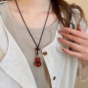 Ethnic wood gourd heart pendant necklace with wax rope cord for women on model