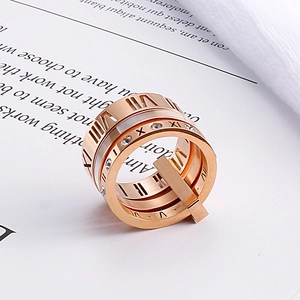 Detail of rose gold roman numeral hollow ring set with white cubic zirconia