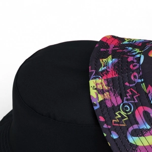 Detail of double-sided fisherman hat showing colorful graffiti brim and precise stitching