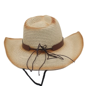 Detail of woven straw texture and faux leather trim on classic western cowboy sun hat