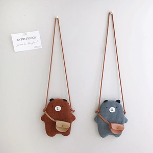 Detail view of corduroy texture on cute bear-shaped crossbody bags in brown and grey colors