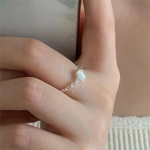 Macro shot of S925 sterling silver chain ring with oval white opal stone detail