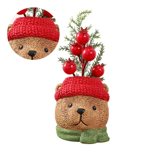 Christmas bear resin ornament with red knit hat, green scarf, and festive berry branch