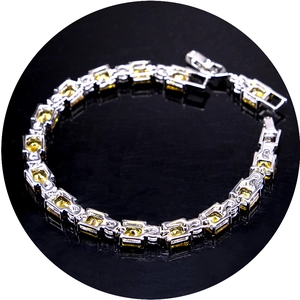 Elegant silver bracelet featuring square yellow zircon stones on a black background