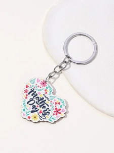Macro detail of heart-shaped wooden Mother's Day keychain with floral print and silver ring