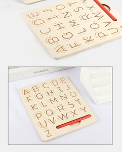 Detail of wooden alphabet tracing board with uppercase letters and stroke arrows