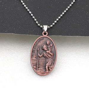 Close-up of vintage bronze St. Christopher pendant with classic beaded chain necklace