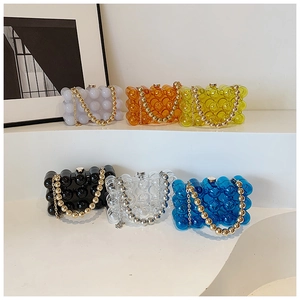 Close-up of pearl acrylic evening clutches with wave bubble texture in six vibrant colors