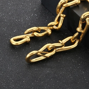 Macro view of gold-plated stainless steel square nail links with industrial finish