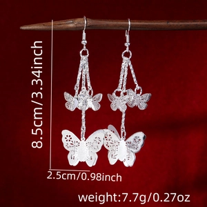 Macro detail of bohemian butterfly tassel earrings showing length 8.5cm and width 2.5cm