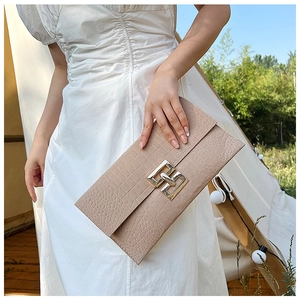 Fashionable beige faux crocodile envelope clutch bag with elegant golden metal clasp