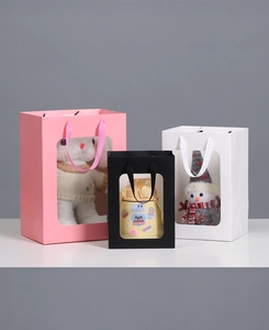 Three premium paper gift bags with clear windows and ribbon handles in pink, black and white