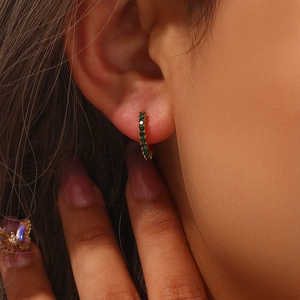 Minimalist 18K gold plated hoop earrings with micro-paved green zircon on a model