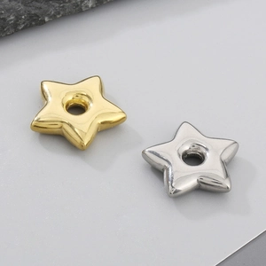 Macro view of gold and silver star beads with center holes for DIY jewelry making