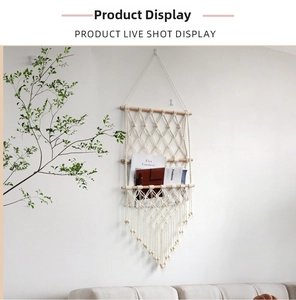 Detail of bohemian handmade macrame wall shelf with cotton rope tassels and wooden beads