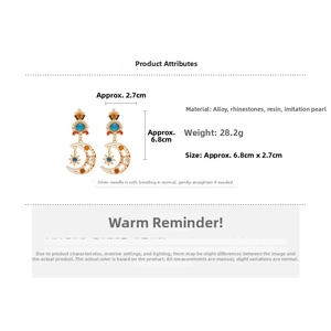 Detailed view of moon and star earrings with resin pearls and measurements 6.8cm long