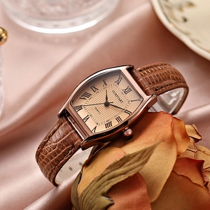 Détail d'une montre vintage en or rose avec chiffres romains sur tissu de soie