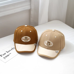 Close-up of baby baseball cap featuring cute bear embroidery and contrast color brim