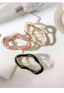 Detailed set of three irregular wave metal hair claws in pink, beige, and black colors