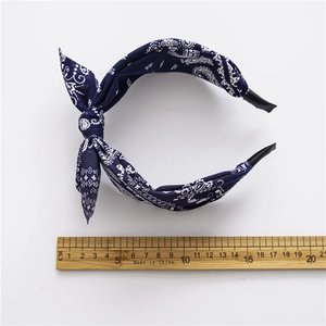 Dark blue paisley headband with bunny ear knot design showing 14cm width measurement