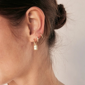 Elegant gold S925 silver star hoop earrings with rectangular charm worn by a model
