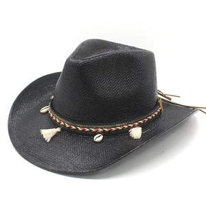 Close-up of black straw cowboy hat with ethnic beads shell and tassel trim decoration