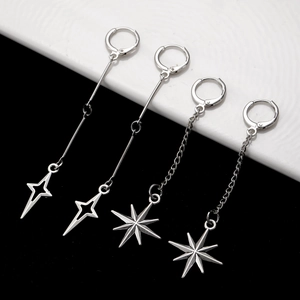 Detailed view of silver star dangle earrings with minimalist starburst and north star charms
