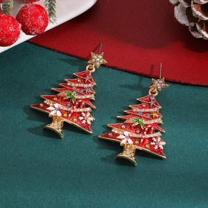 Detail of Christmas tree earrings with red enamel, colored crystals and festive charms