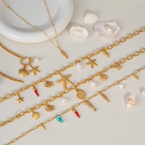 Gold ocean themed necklace and bracelet set with starfish shell charms and pearls
