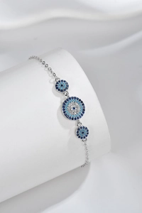 Macro detail of S925 sterling silver evil eye bracelet with blue and white crystals