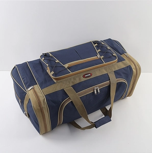 Detail view of large navy blue oxford travel bag with multiple pockets and top bungee cord