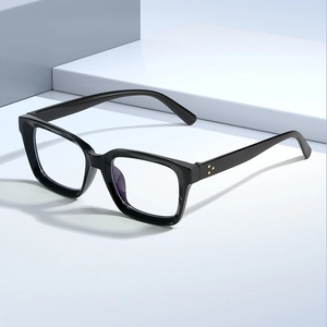 Square black frame anti-blue light glasses with rivet details on minimalist studio backdrop