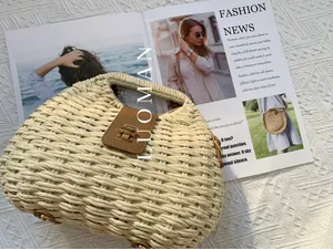 Detail of hand-woven straw bag with brown leather flap and golden metal twist lock