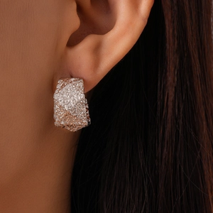 Minimalist geometric C-shaped textured silver earrings with crushed foil metal finish