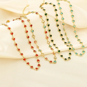 Golden stainless steel necklace set with multi-colored glass heart charms on silk
