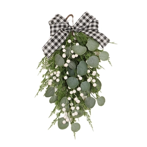 Christmas eucalyptus swag with pine branches, white berries and buffalo check bow decor