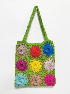 Detail of colorful hand-crocheted floral tote bag with 3D stitch flower patterns