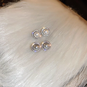 Elegant white and grey pearl stud earrings with zircon halo on white plush background