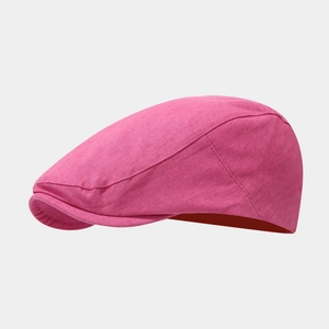 Detail of vibrant hot pink newsboy cap with premium cotton twill texture and curved brim