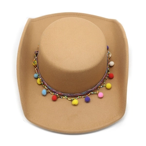 Ethnic khaki cowboy hat with colorful beaded band and tassels on a white background