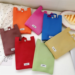 Colorful knitted crossbody phone bags in various colors for women on white background