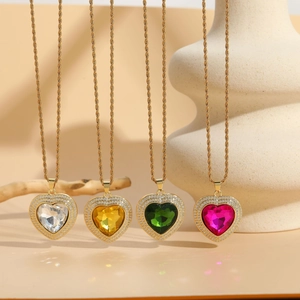 Macro detail of heart zircon necklaces in four colors with gold twisted ropes