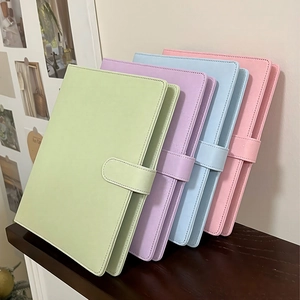 Close-up of colorful PU leather loose-leaf binders in pastel green, purple, blue, and pink