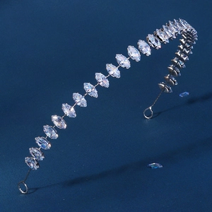 Elegant silver leaf headband with marquise-cut zircon crystals on blue background
