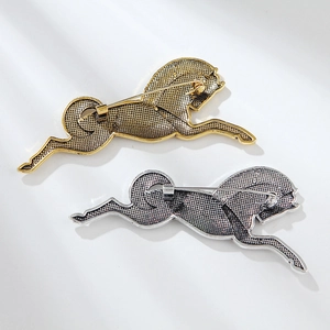 Detailed back view of vintage horse brooches in gold and silver showing secure pin closure