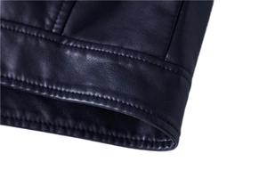 Close-up of premium black leather jacket showing precise stitching and smooth texture