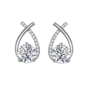 Macro shot of silver stud earrings with a large round center stone and pave setting