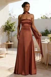 Detail of elegant backless satin evening gown in bronze with a sleek strapless silhouette