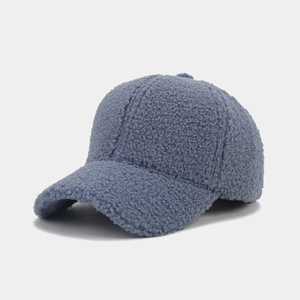 Detailed texture of blue-gray sherpa fleece fabric on a warm winter baseball cap